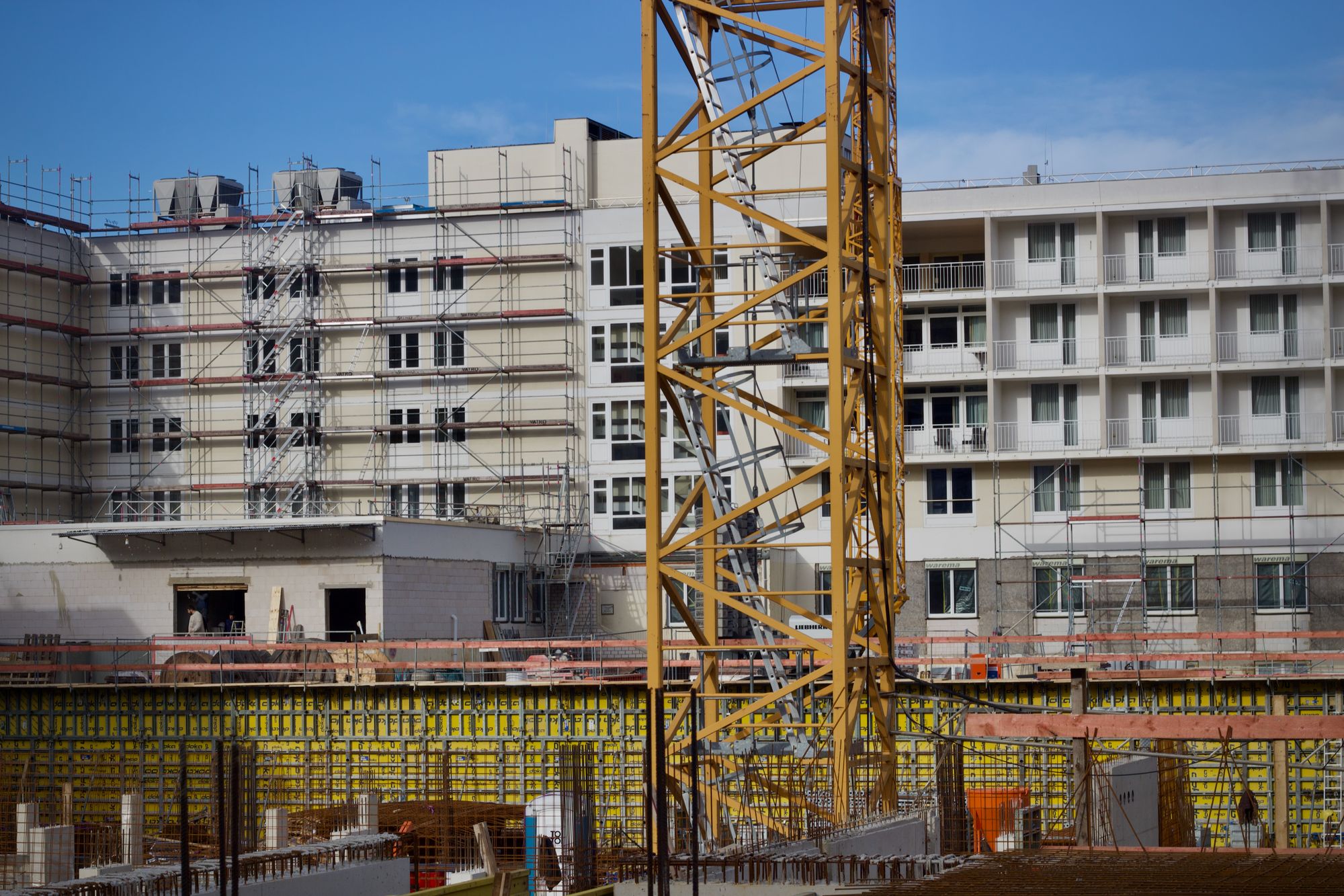 Urban commercial construction site with crane and building