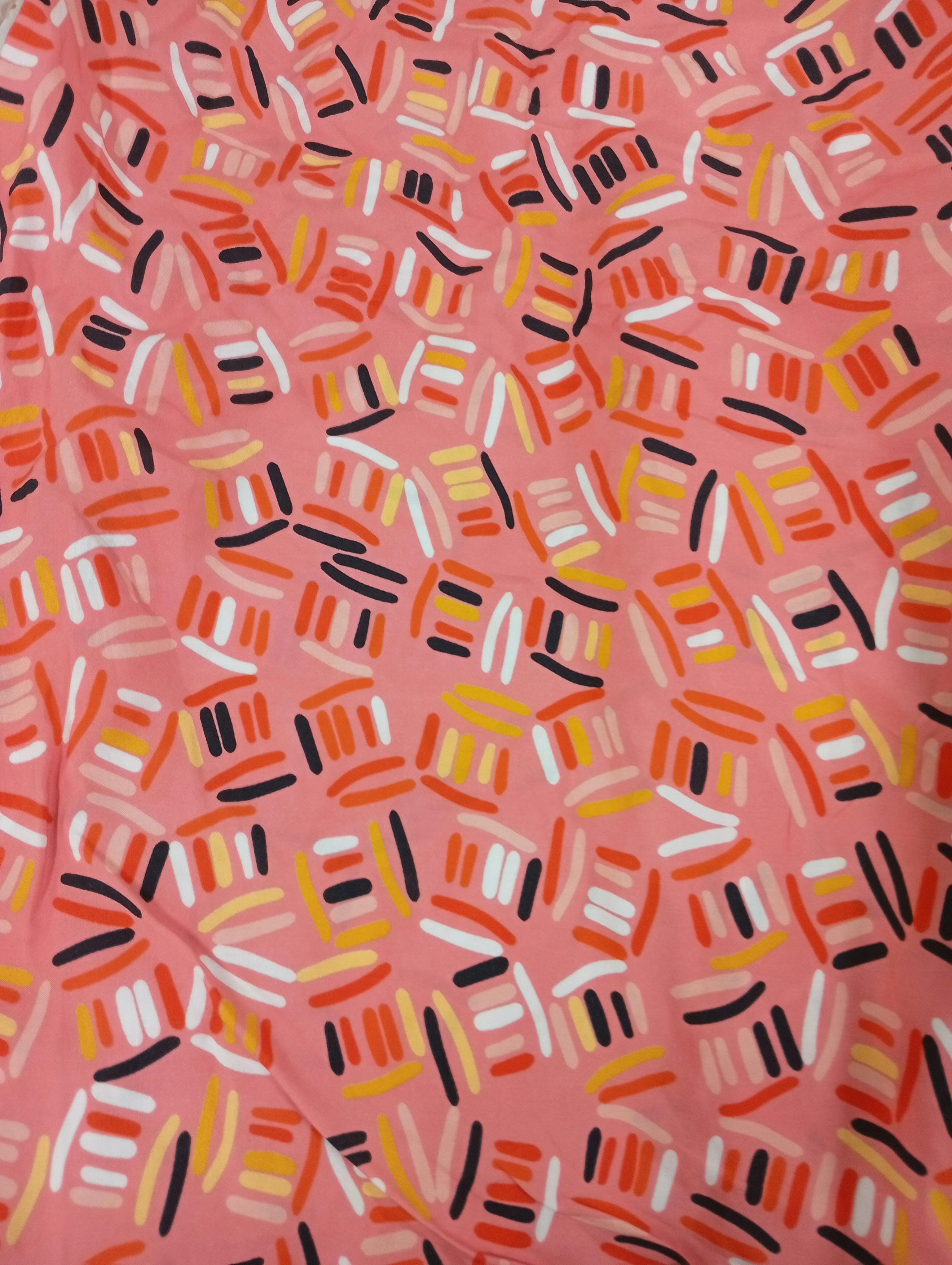 Free Vibrant abstract pattern on pink fabric featuring diverse colorful shapes. Stock Photo