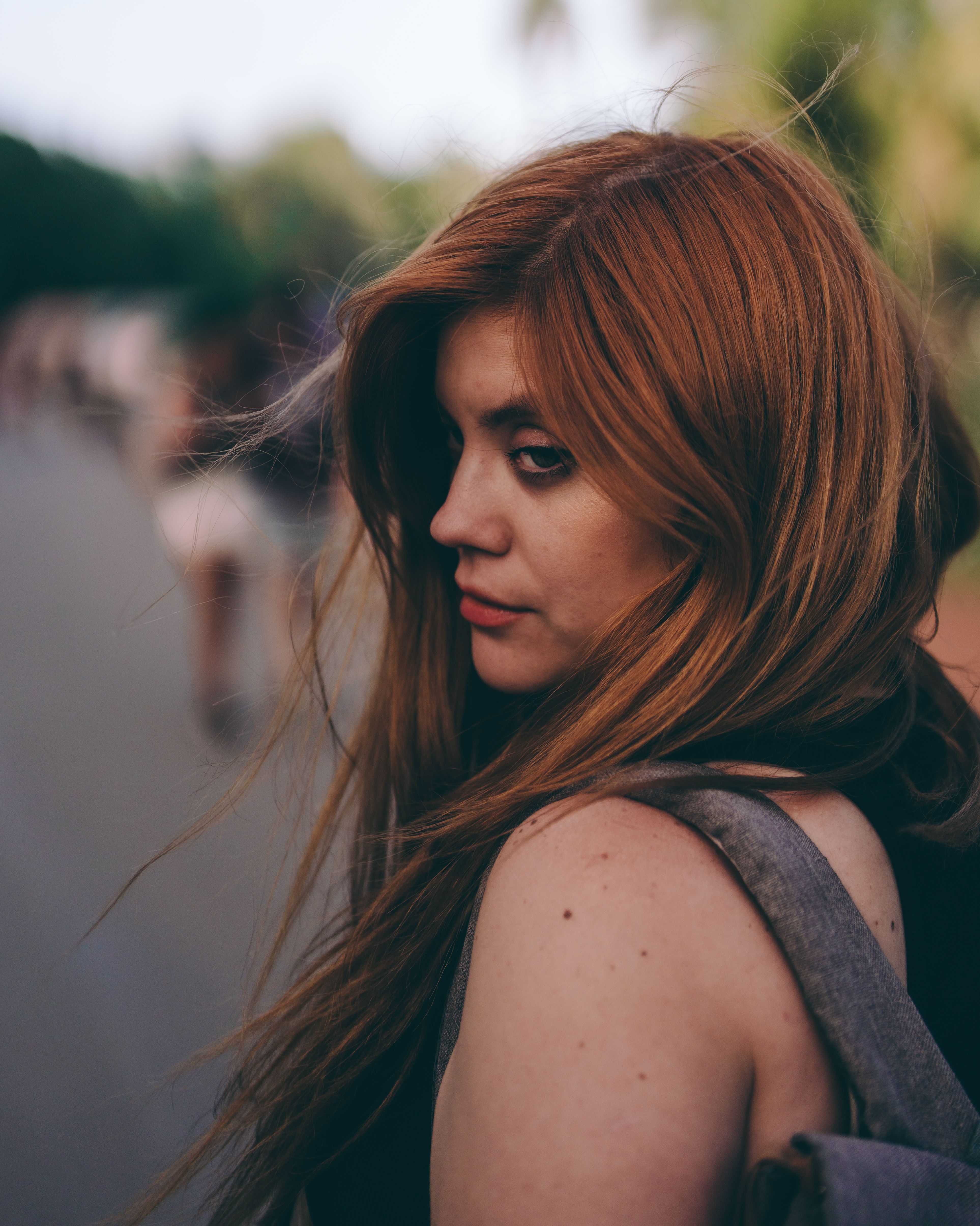 Woman with Red Hair Outdoors in Soft Lighting · Free Stock Photo