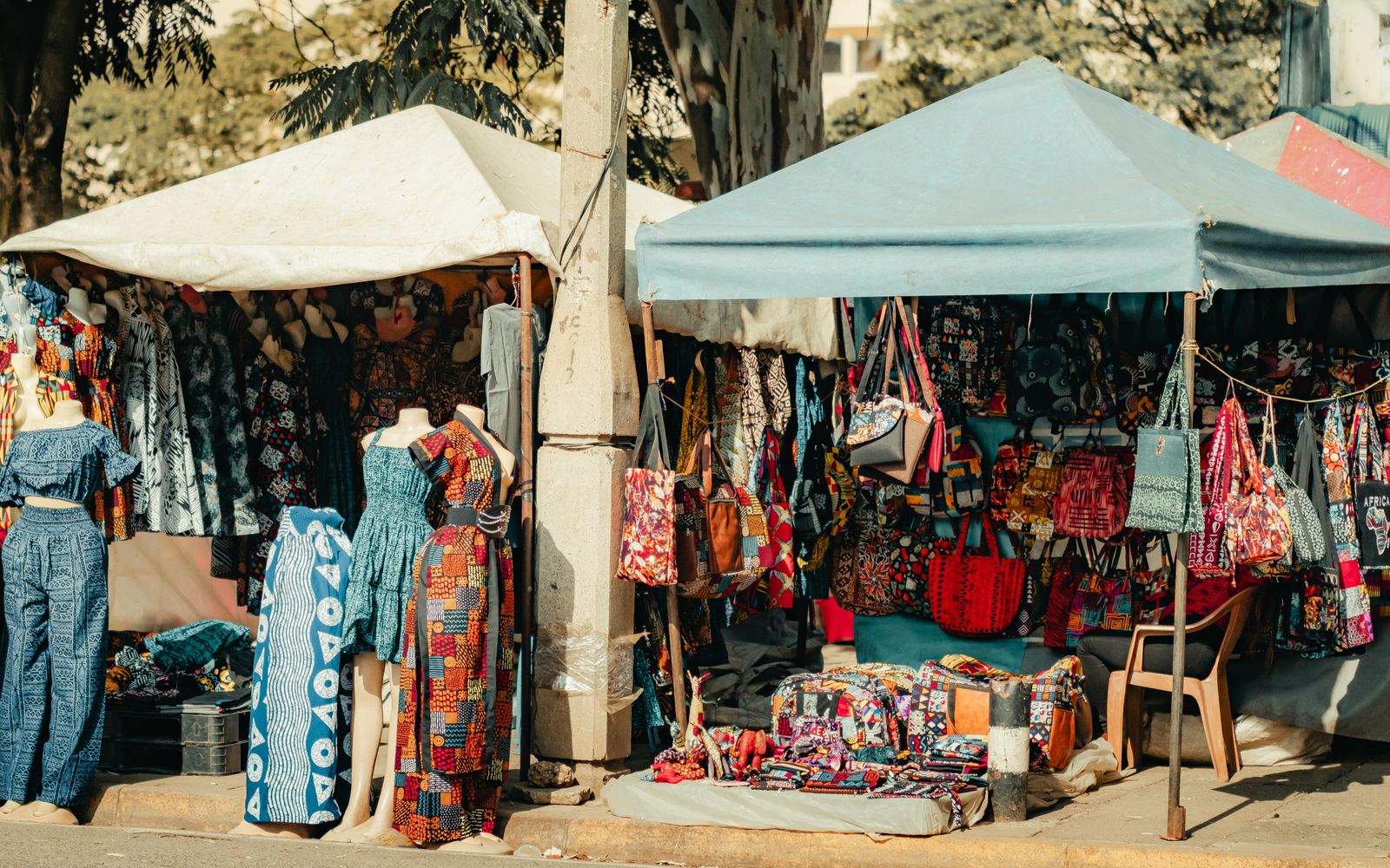 Colourful Kenyan textiles, dresses, bags and crafts displayed at a Nairobi market