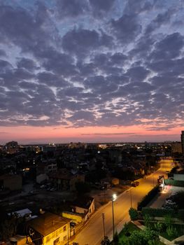 Evening cityscape of Konya, Türkiye, showcasing vibrant sunset skies and dramatic clouds.