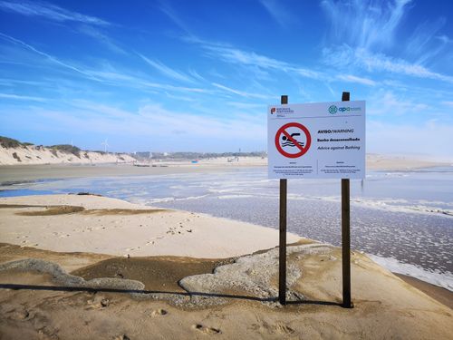 Free A warning sign at Tocha Beach advises against bathing in Coimbra, Portugal. Stock Photo