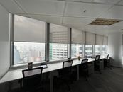 Sleek and modern office interior with desk and chairs overlooking a cityscape.