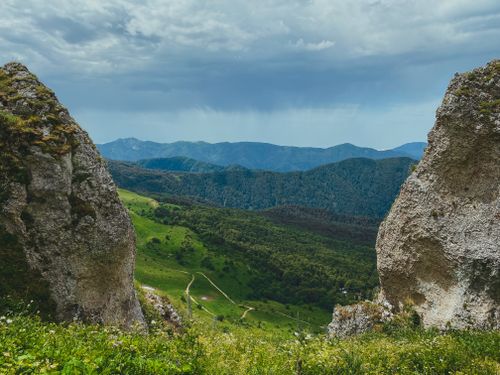 Free Panoramic view of lush green valleys and rugged mountains in Adygea, Russia. Stock Photo