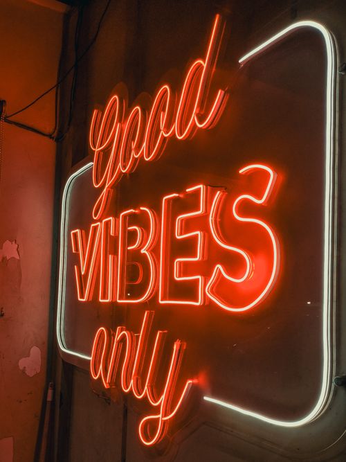 Free A vibrant red neon sign reading 'Good Vibes Only' with a warm glow, perfect for creating an upbeat atmosphere. Stock Photo