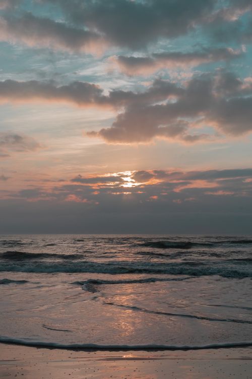 Free Captivating sunset seascape at Imbituba Beach, Santa Catarina, Brazil captured in warm hues. Stock Photo