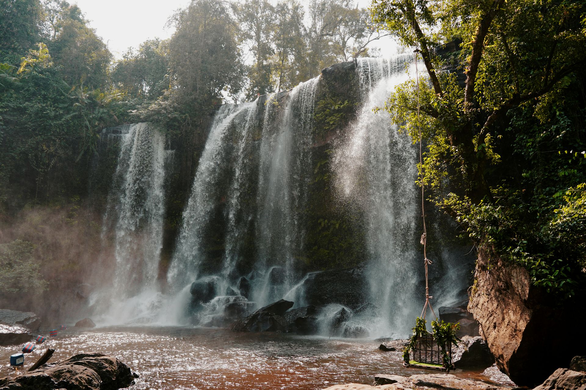 Waterfall cascading through lush tropical jungle, Cambodia