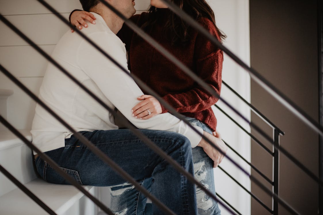 Free Man and Woman Sitting on Stairs Stock Photo