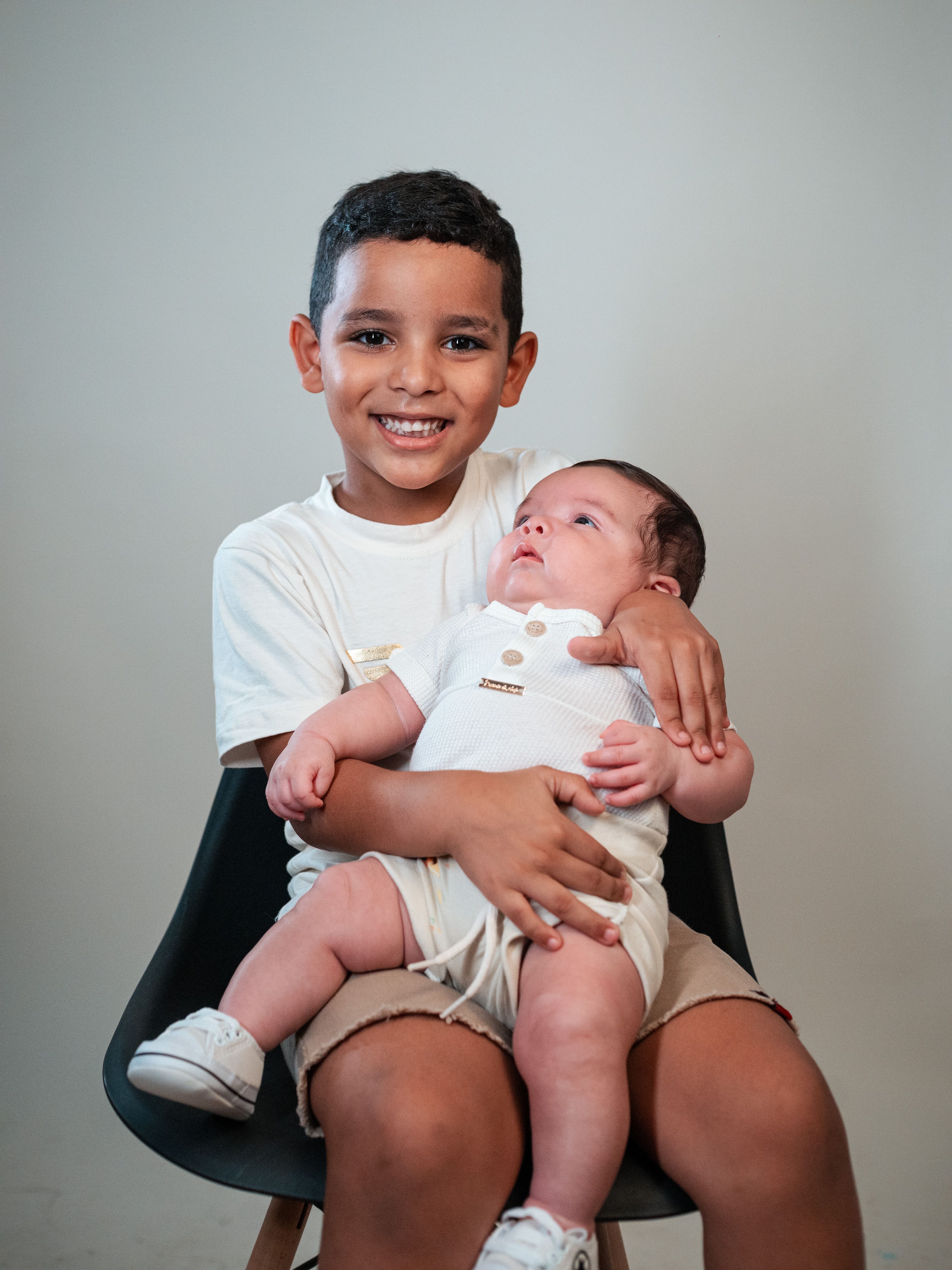 Happy Siblings Portrait in Minimalist Setting · Free Stock Photo