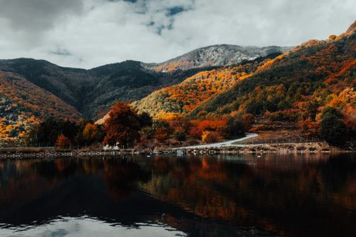 Free Breathtaking autumn view of mountains and lake in Panagitsa, Greece. Stock Photo