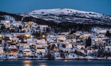 黄昏时分，迷人的白雪皑皑的村庄映衬着挪威的冬季景观