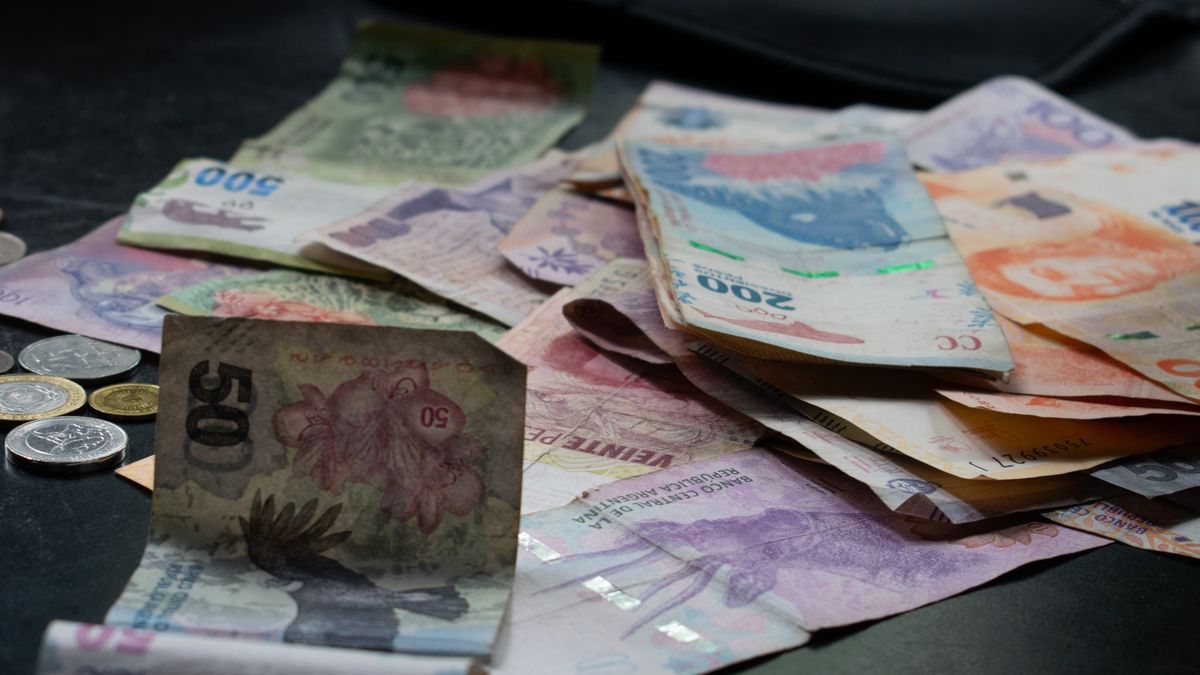 A mix of international banknotes and coins displayed on a table, highlighting diverse world currencies.