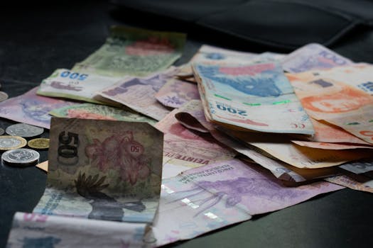 A mix of international banknotes and coins displayed on a table, highlighting diverse world currencies.