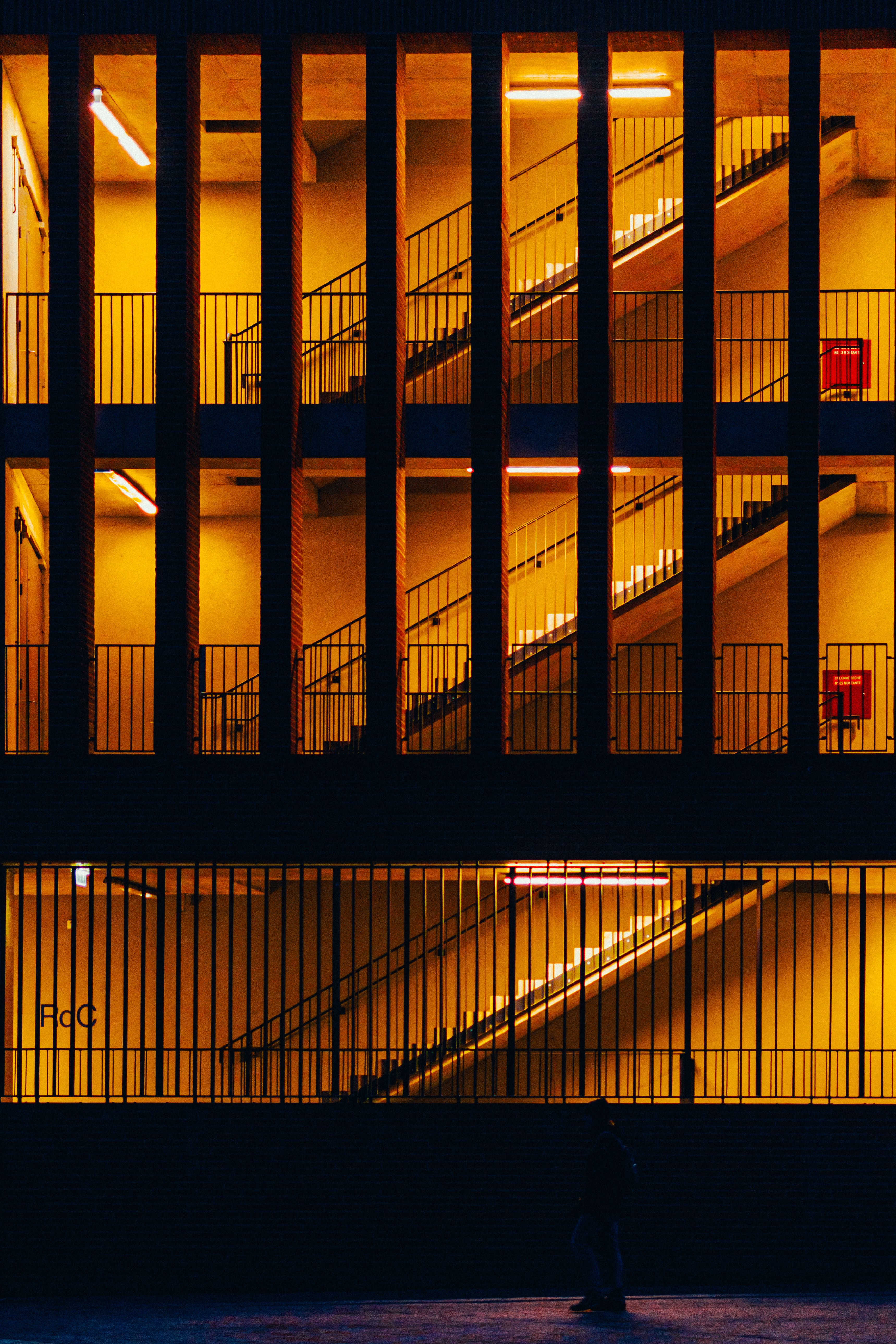 Modern Building with Illuminated Staircase at Night · Free Stock Photo