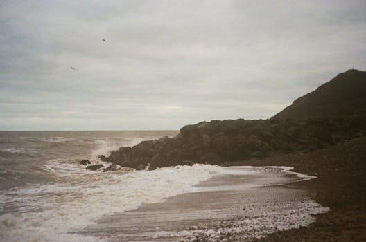 Moody seascape with waves crashing on Bray Beach, Ireland.