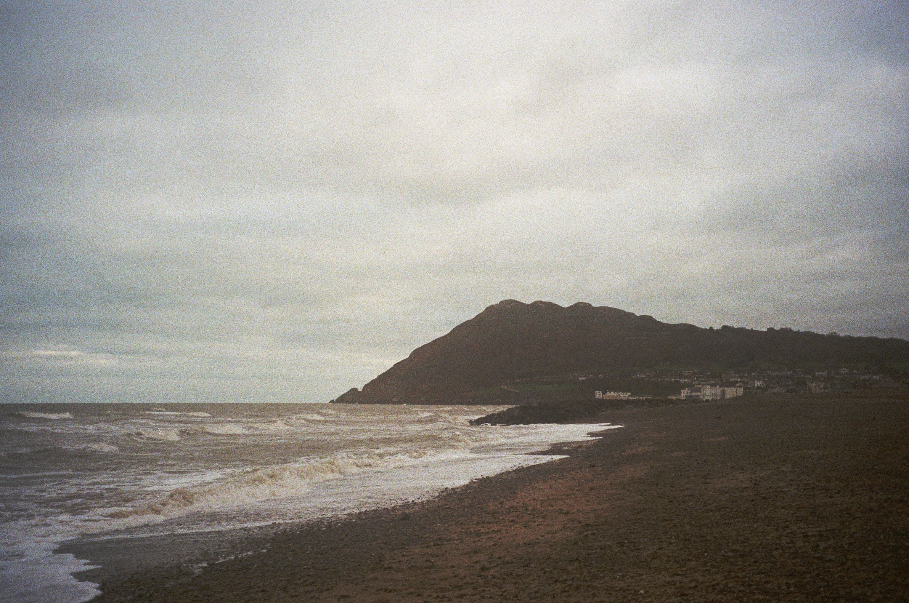 Stormy seascape at Bray, County Wicklow, Ireland with waves crashing against the shore.