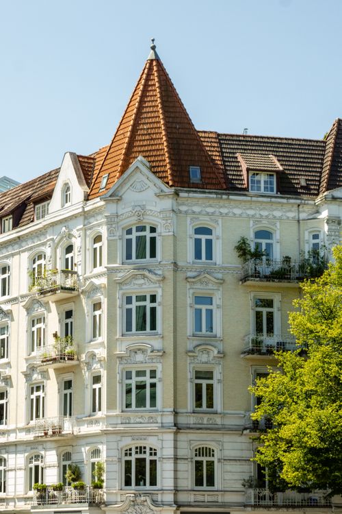 Free Elegant historic building with ornate facade and red rooftop in Hamburg, Germany. Stock Photo