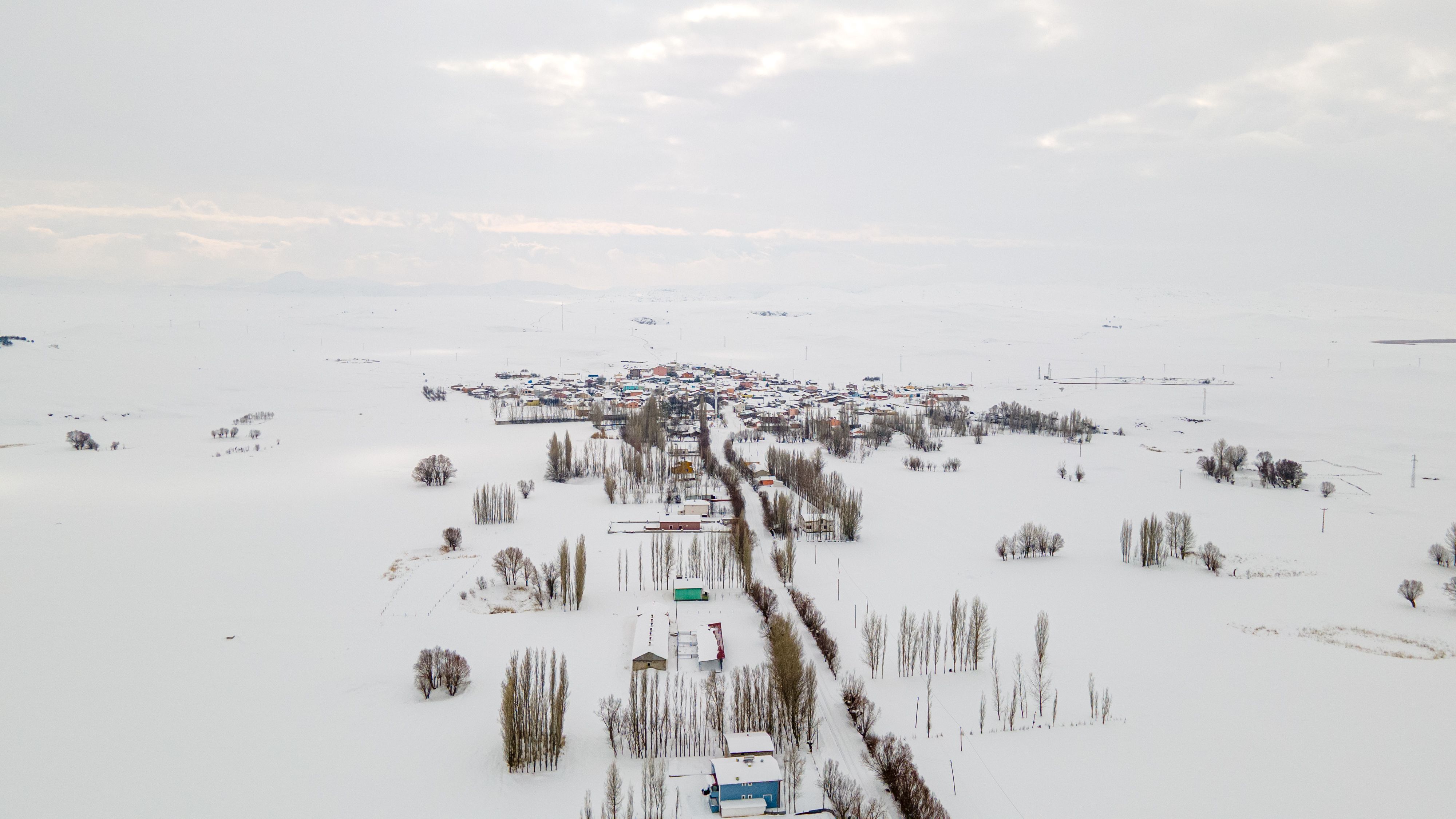 Aerial View of Snow-Covered Rural Village in Winter · Free Stock Photo