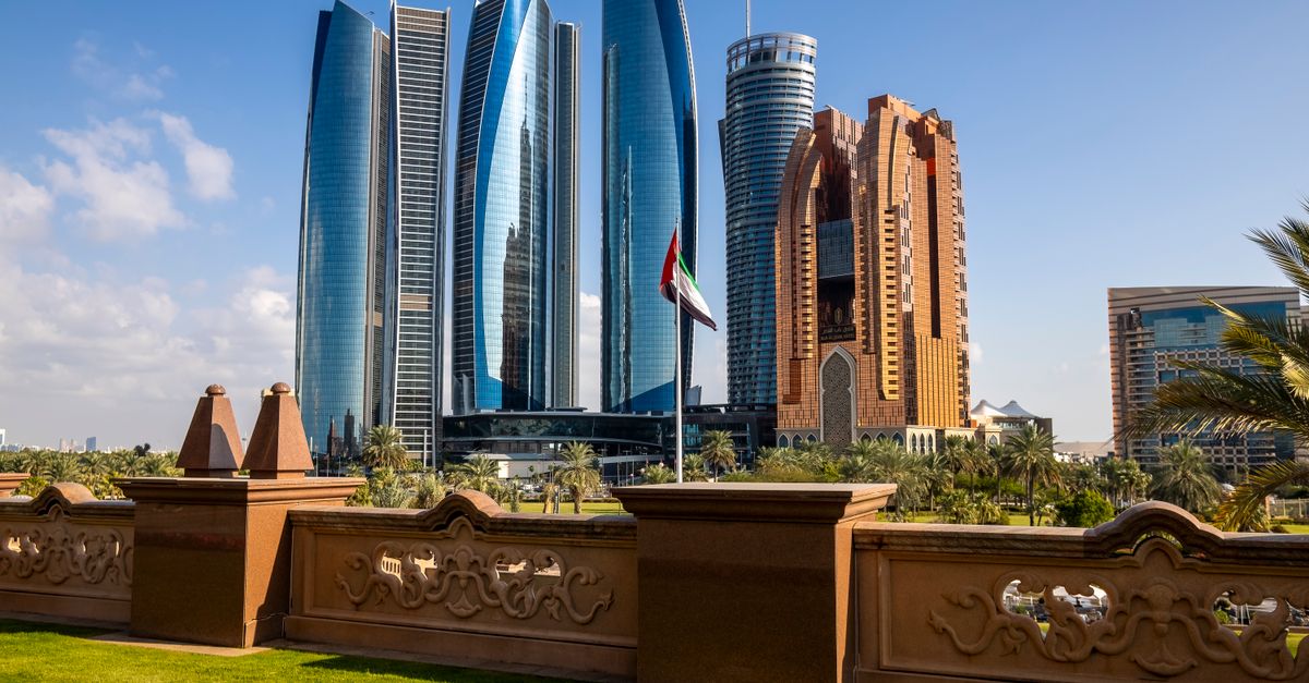 Stunning view of Abu Dhabi's Etihad Towers and city skyline under clear blue sky.