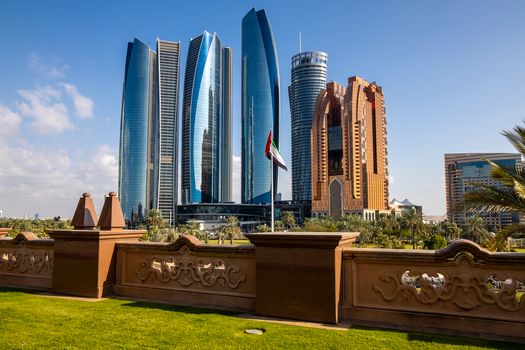 Stunning view of Abu Dhabi's Etihad Towers and city skyline under clear blue sky.