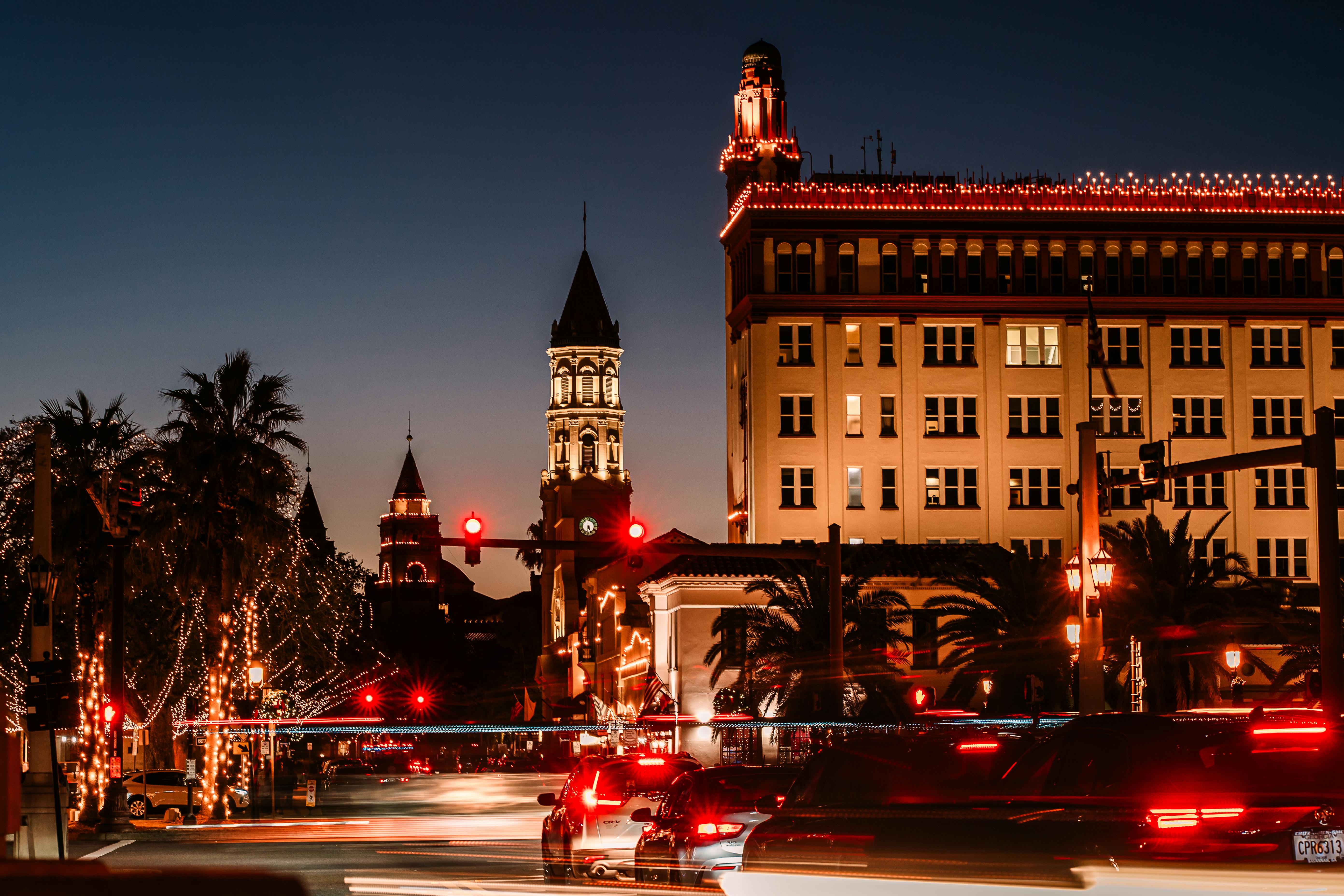 Beautifully lit St. Augustine architecture during twilight with festive lights.