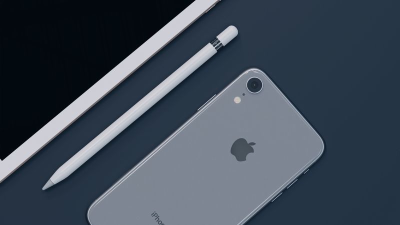 Sleek design of Apple iPhone, iPad, and Pencil highlighting modern technology.