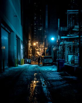 A mysterious alleyway in Chicago, Illinois, featuring dramatic lighting and urban architecture.