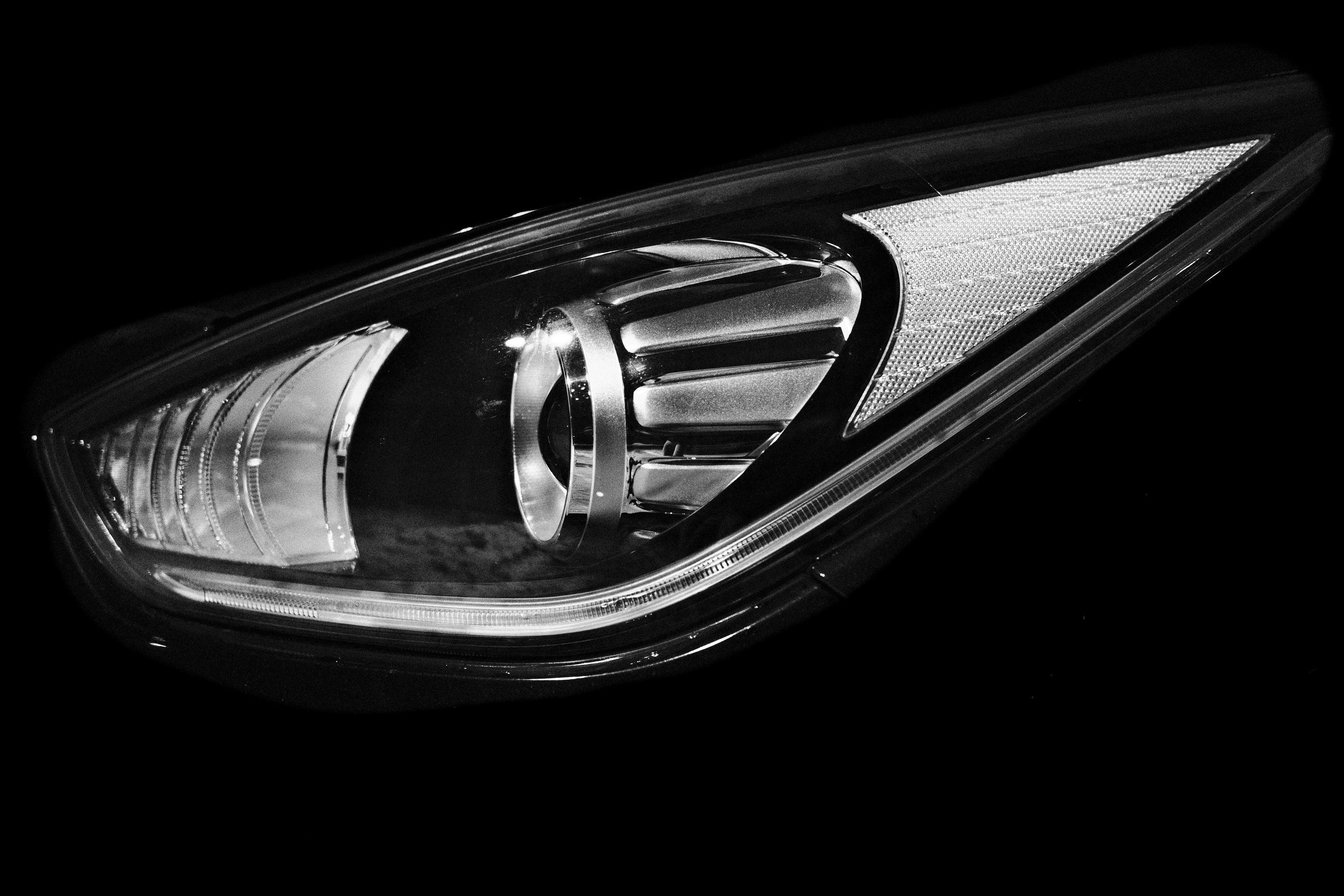 A detailed close-up of a modern car headlight showing its sleek design.