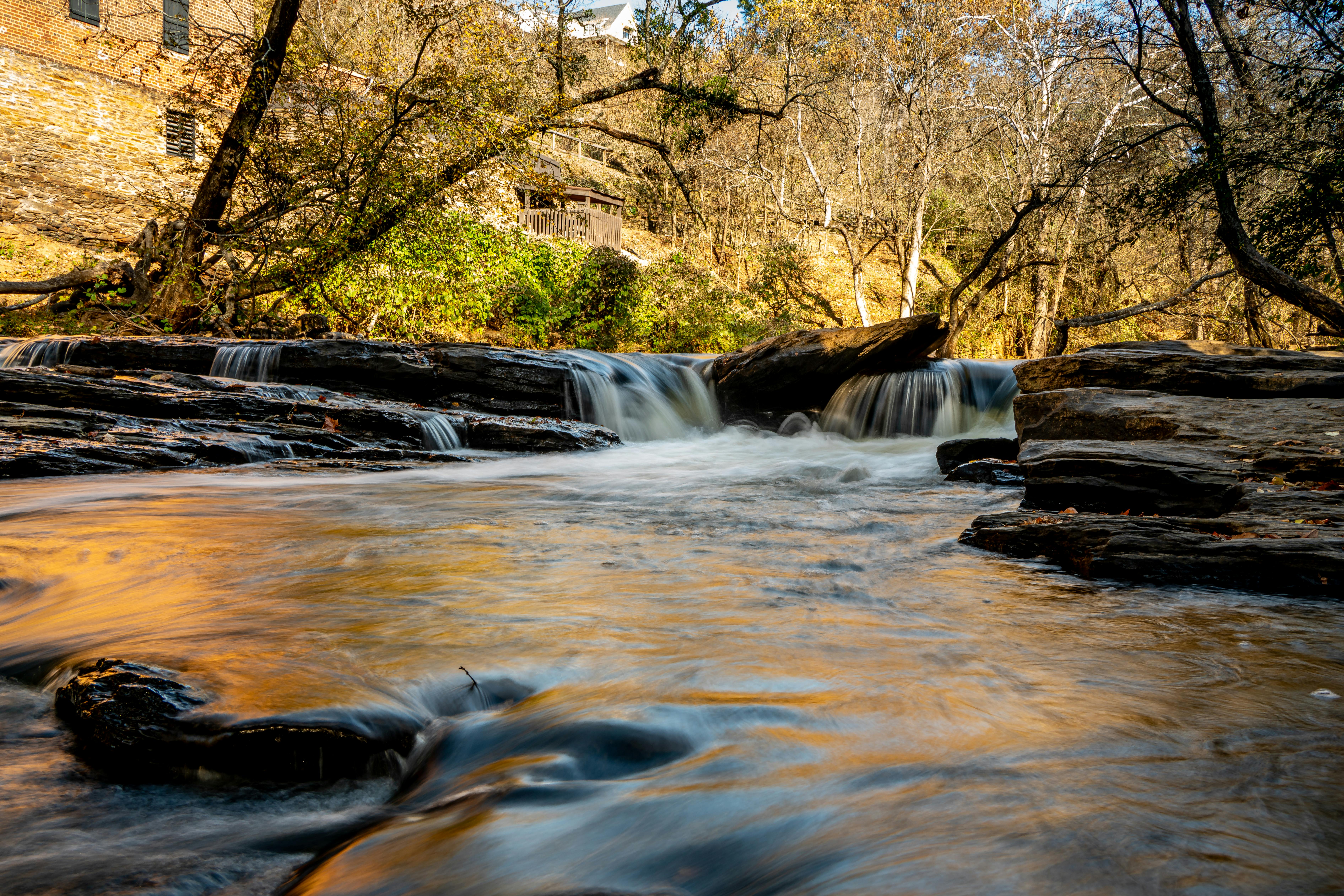 Tranquil waterfall scene surrounded by autumn foliage in scenic Georgia.