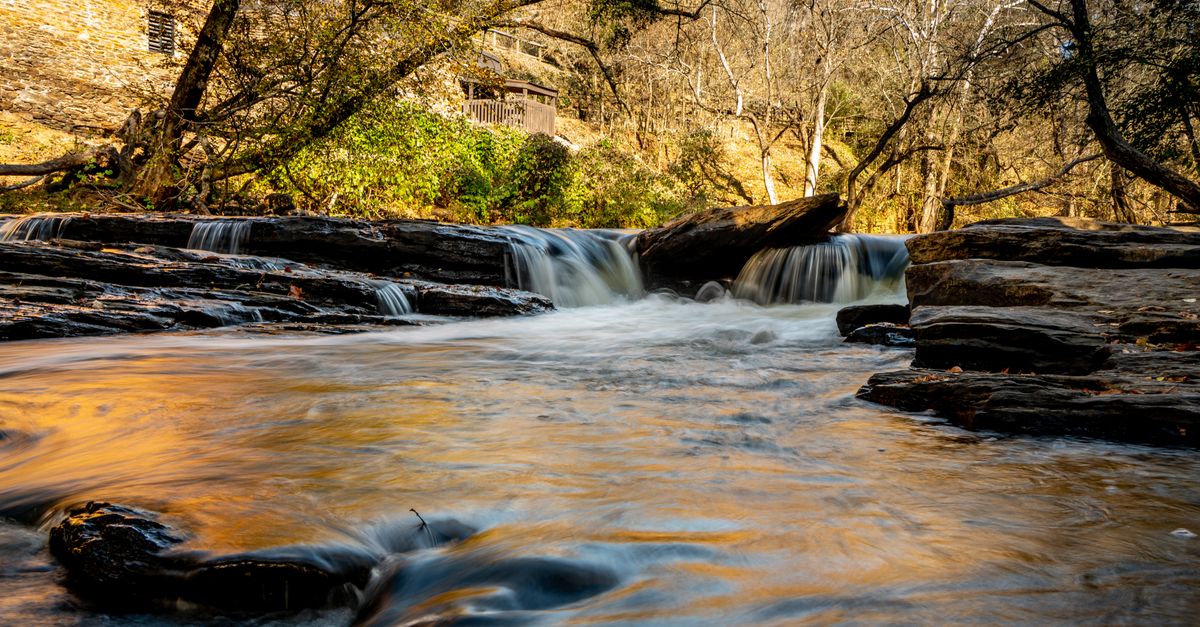 Tranquil waterfall scene surrounded by autumn foliage in scenic Georgia.
