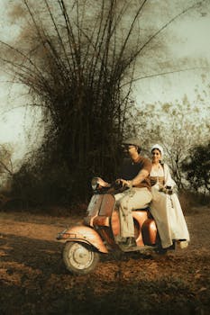 A couple enjoys a rural ride on a vintage scooter amidst natural scenery, evoking a nostalgic and adventurous vibe.