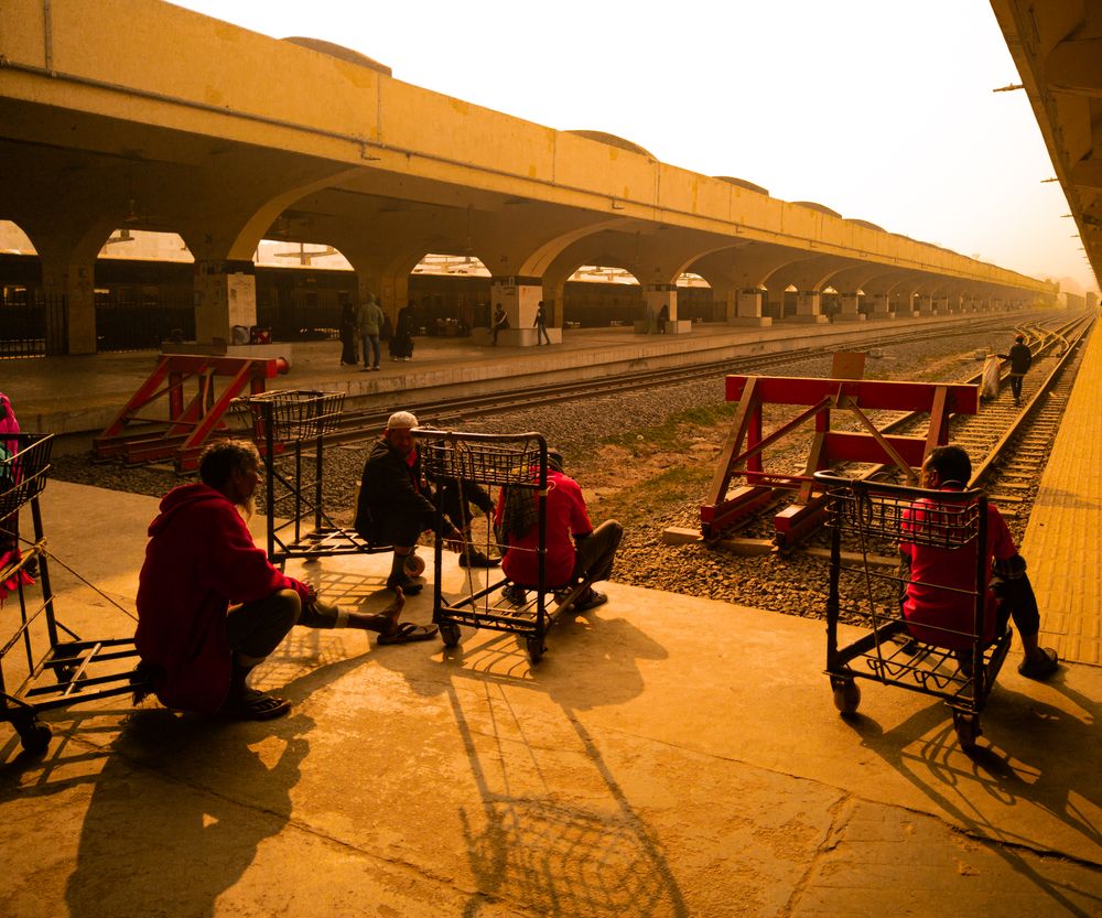 Busy Dhaka railway station at golden hour