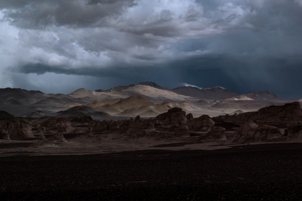 Moody desert landscape under storm clouds — photo by Gabii Fernandez on Pexels