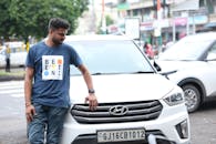 Casual Man Leaning on a White Hyundai Car