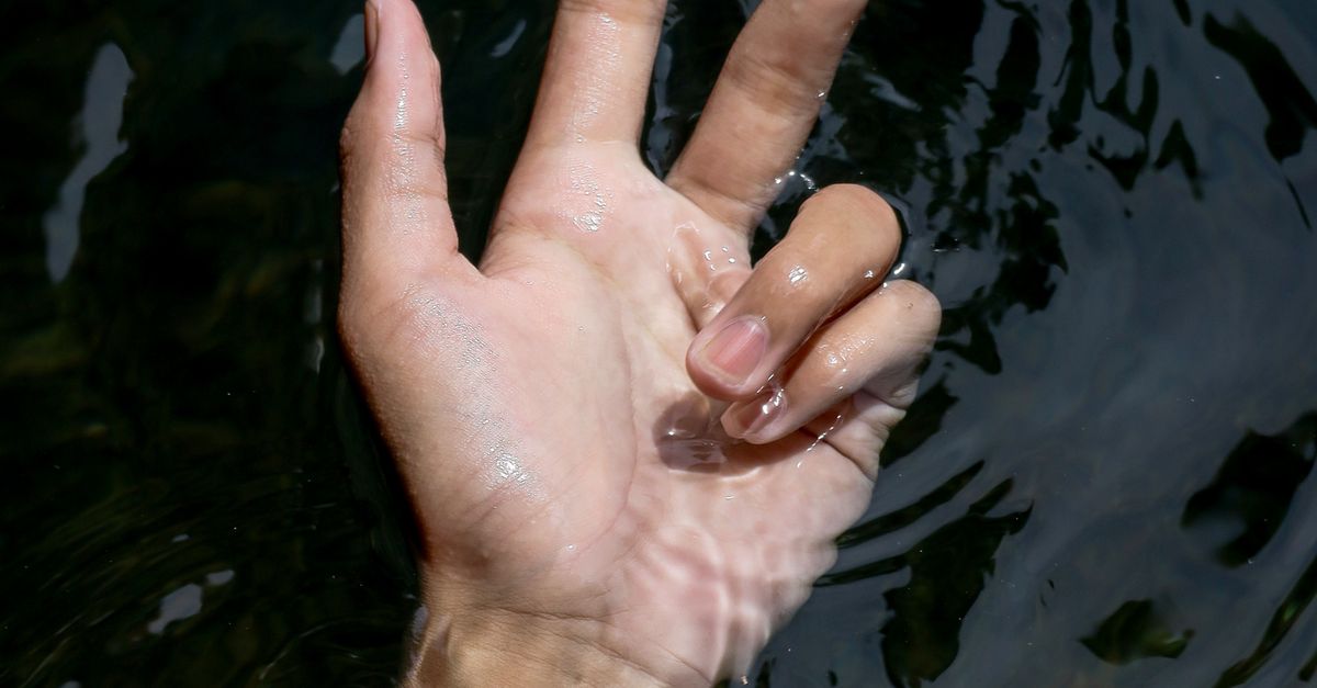 Hand Emerging Hand Emerging from Water Displaying Peace Sign · Free Stock Photo