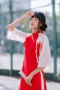 Portrait of Woman in Red Cheongsam Outdoors