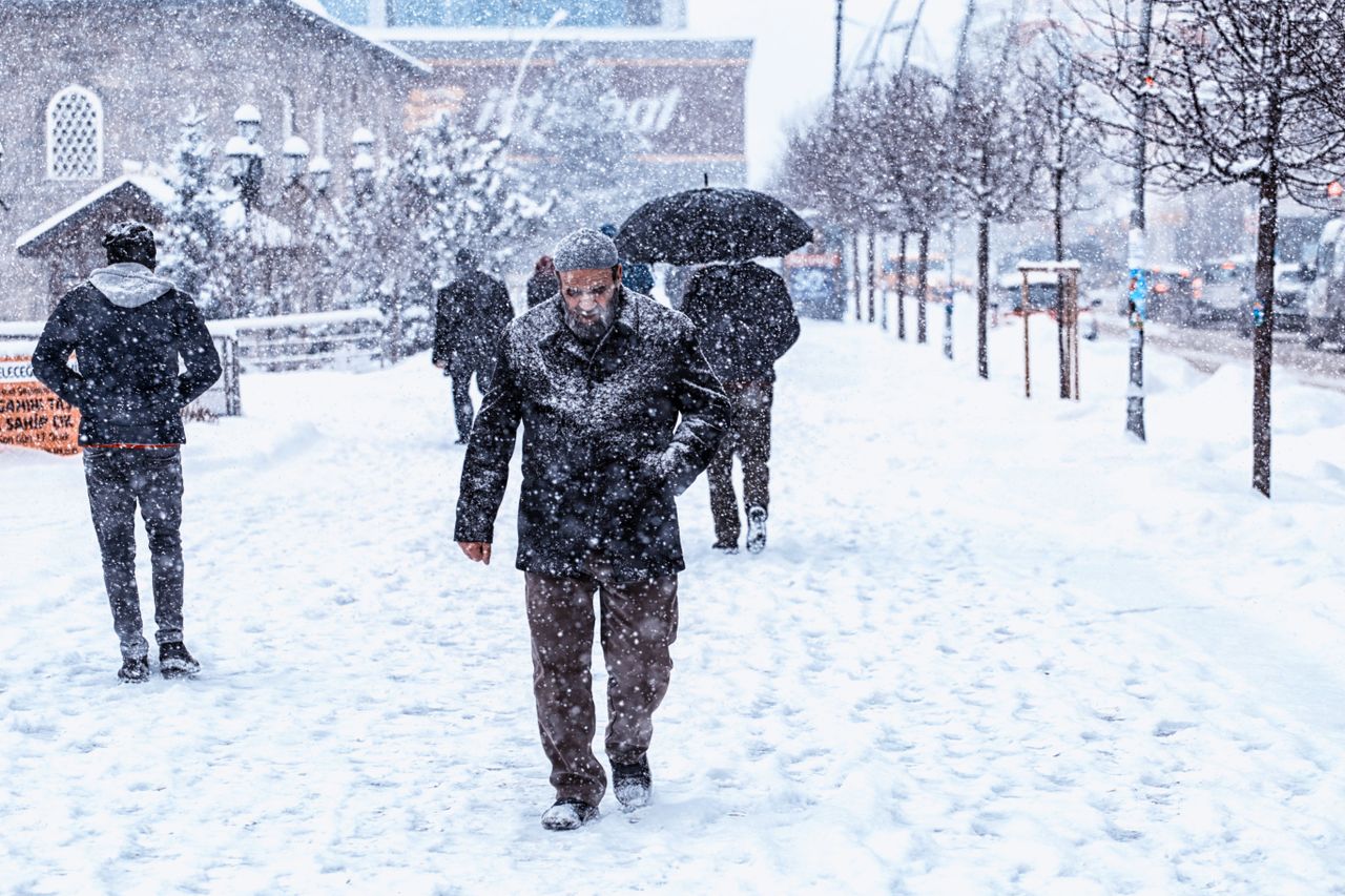 People walking down a snow-covered street