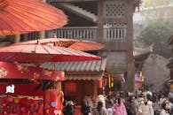 Traditional Asian Market Scene with Red Umbrellas