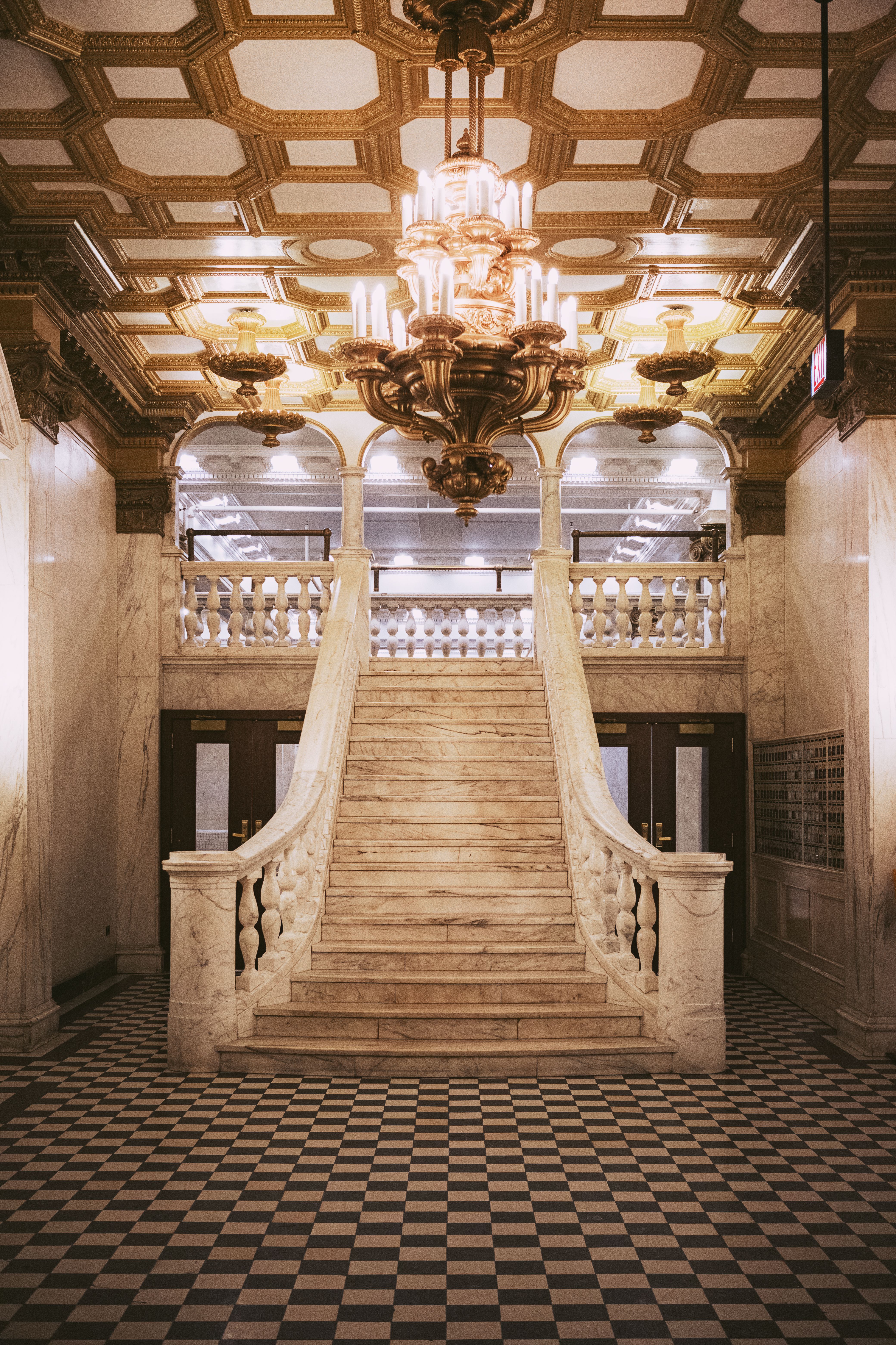 Dramatic chandelier lighting in luxury foyer space