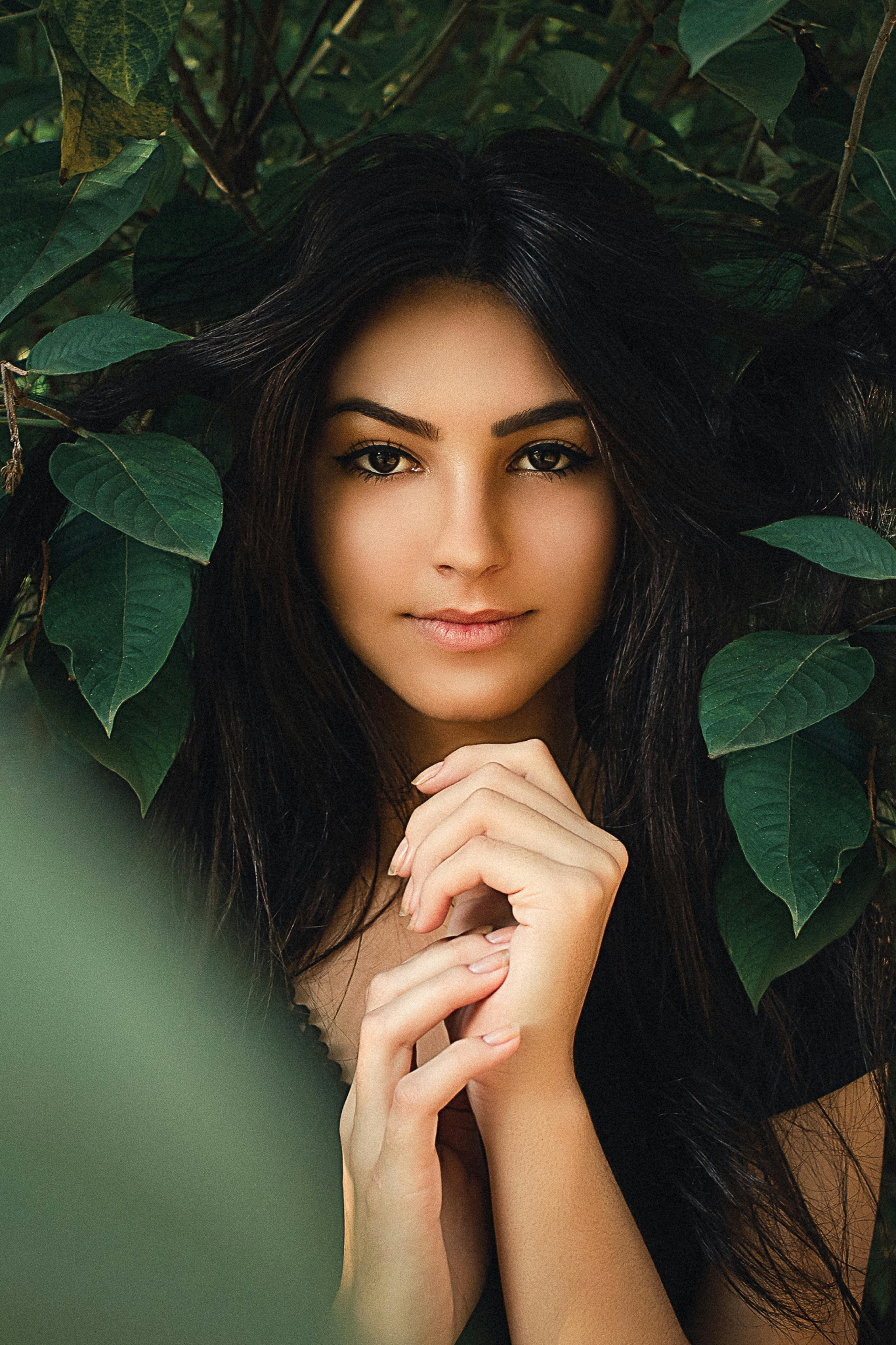 woman standing near green leaves