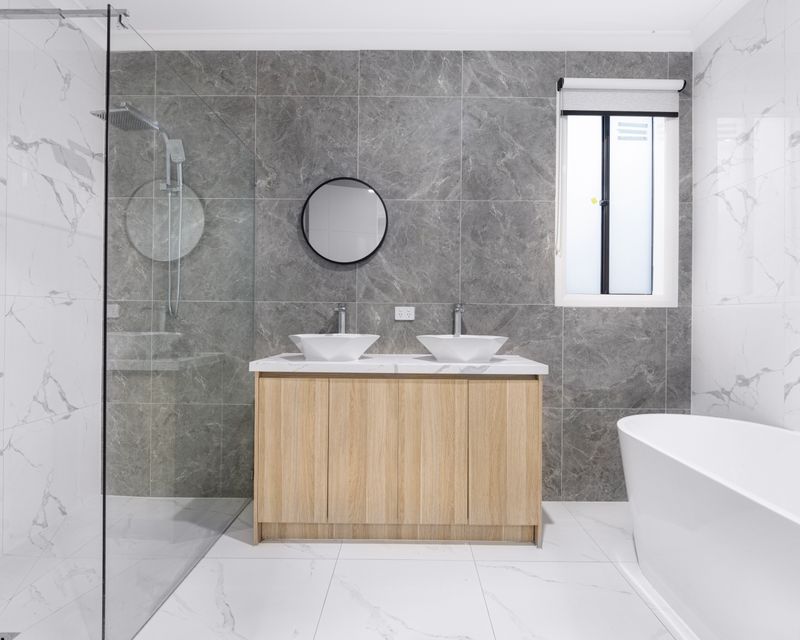 Modern bathroom with marble tiles and glass shower