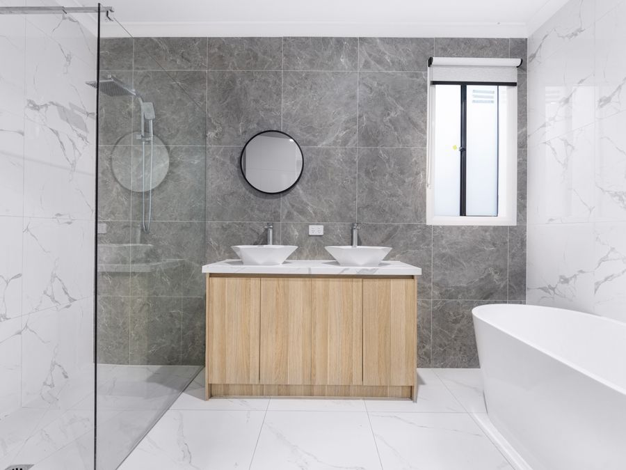 Modern bathroom with dual washbasins and glass shower enclosure