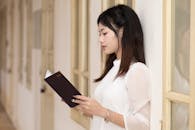 Young Woman Reading a Book in Hanoi Hallway