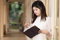 Young Woman Reading Outside in Hanoi