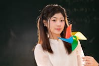 Young Woman with Colorful Pinwheel in Classroom