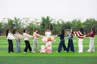 Group of Friends Playing Tug of War with Toy Outdoors