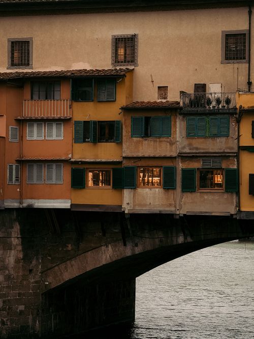 Free Warm evening view of the historic Ponte Vecchio bridge in Florence, Tuscany. Stock Photo