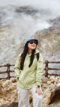 A woman hiker enjoys a scenic view at the Papandayan Volcano in Indonesia.