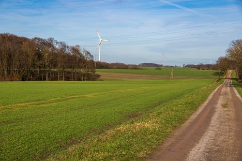 Free Beautiful landscape of green fields and a wind turbine in Coesfeld, Germany. Stock Photo