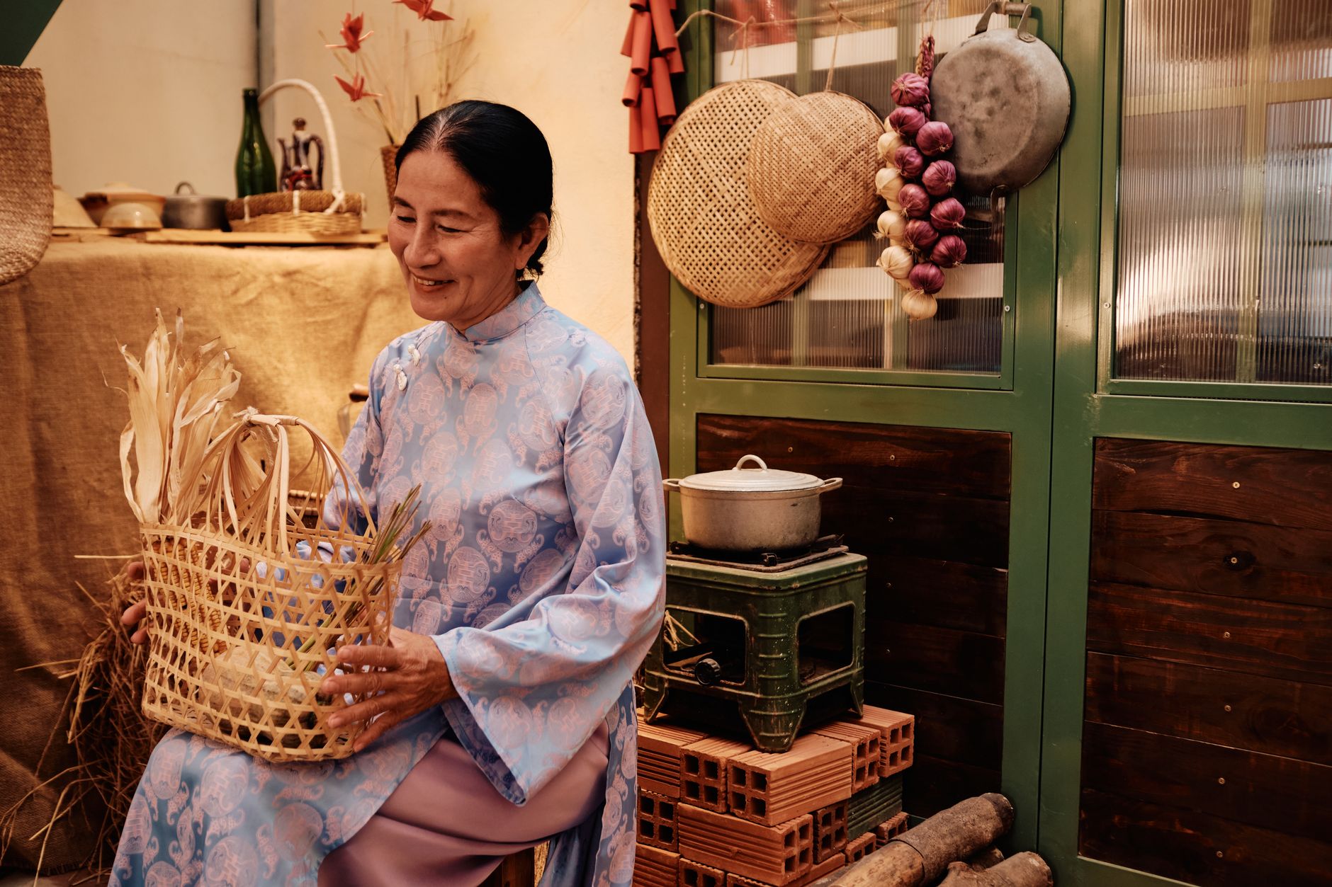 A woman in traditional attire crafting a basket, symbolizing Vietnamese culture and craft.